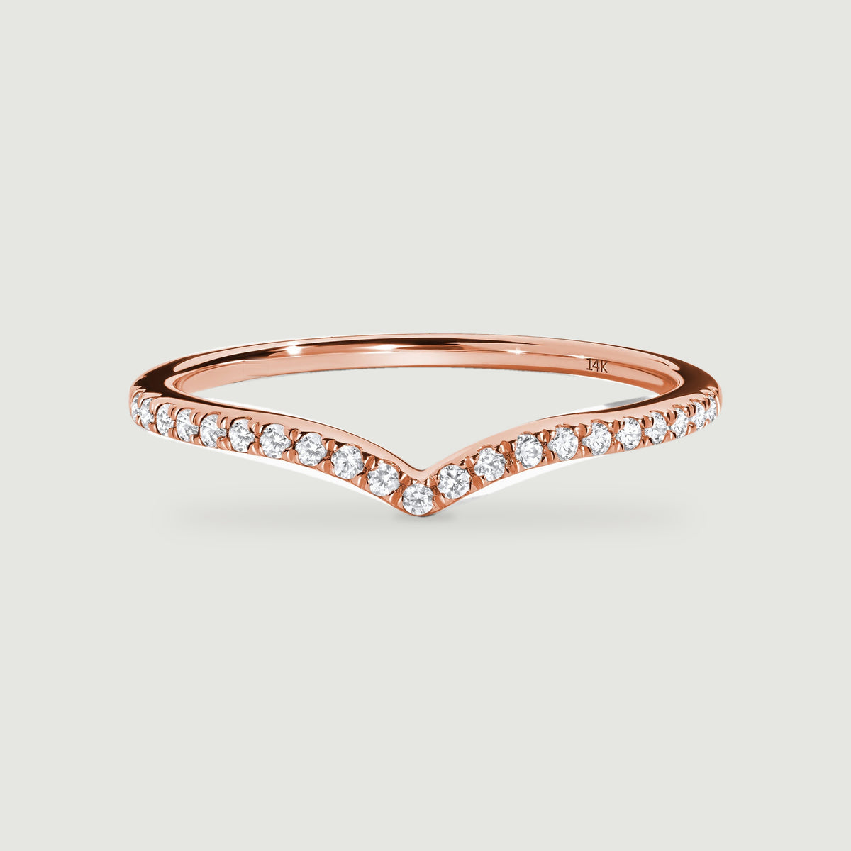 A rose gold diamond band is shown from the front with a curved back and a gently pointed centre.