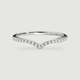 A white gold ring displays a continuous row of round diamonds along its angled front edge.