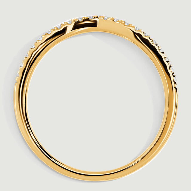 A yellow gold band is viewed from the side, revealing the raised diamond settings and polished inner curve.