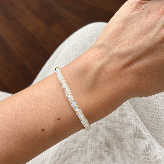 Lunar Tide rainbow moonstone bracelet, yellow gold vermeil wrist scale view. One bracelet; photo props not included.