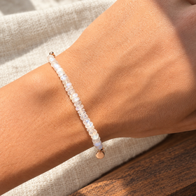 Lunar Tide rainbow moonstone bracelet, rose gold vermeil wrist daylight view. One bracelet; photo props not included.