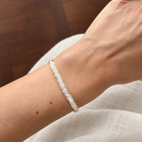 Lunar Tide rainbow moonstone bracelet, rose gold vermeil wrist scale view. One bracelet; photo props not included.