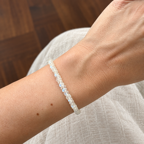 Lunar Tide rainbow moonstone bracelet, sterling silver wrist scale view. One bracelet; photo props not included.
