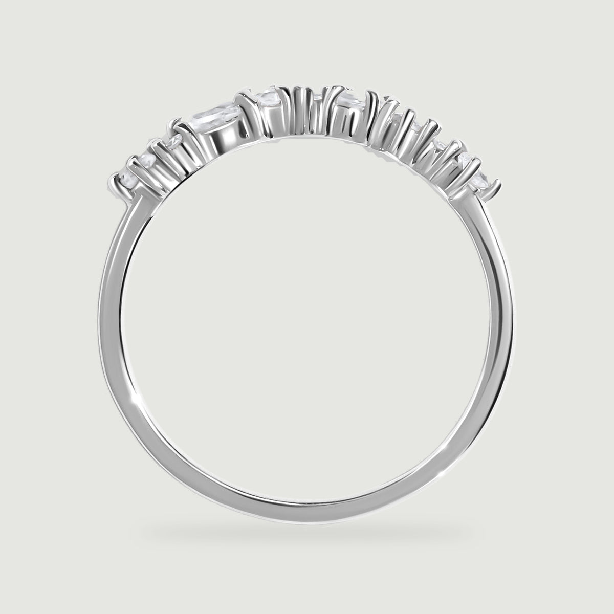 A side view of the white gold ring shows its open stone baskets and polished band.