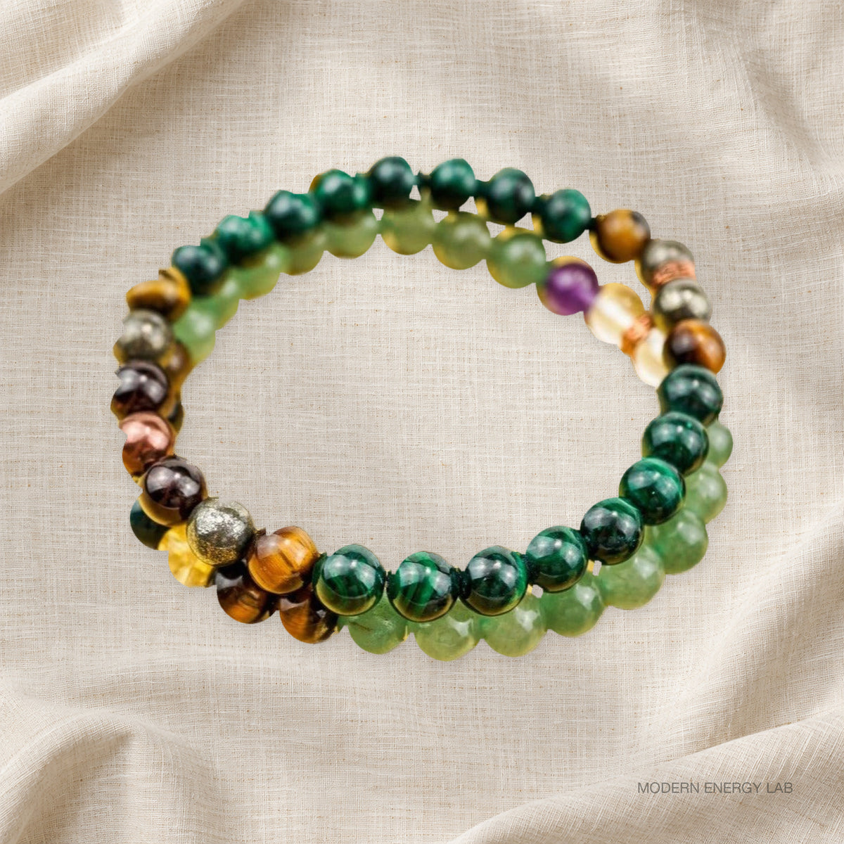 Malachite and citrine bracelet set of two in overlapping loops on ivory linen.