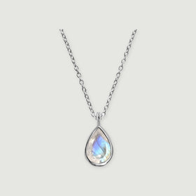 A silver necklace with a pear-shaped moonstone pendant and an oval-link chain is centered on a light gray background.