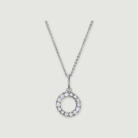 A silver chain holds a stone-set letter O pendant against a light gray background.