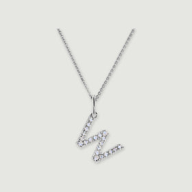 A silver chain holds a stone-set letter W pendant against a light gray background.