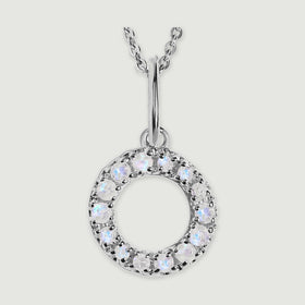 A close view reveals the pale stones and polished silver prongs on the letter O pendant.