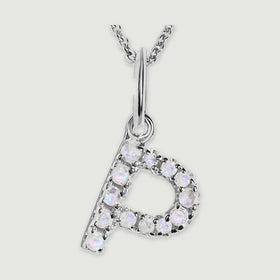 A close view reveals the pale stones and polished silver prongs on the letter P pendant.