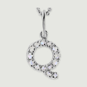 A close view reveals the pale stones and polished silver prongs on the letter Q pendant.