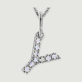 A close view reveals the pale stones and polished silver prongs on the letter Y pendant.