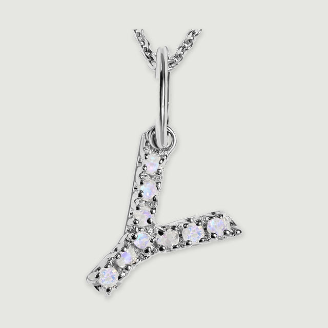 A close view reveals the pale stones and polished silver prongs on the letter Y pendant.
