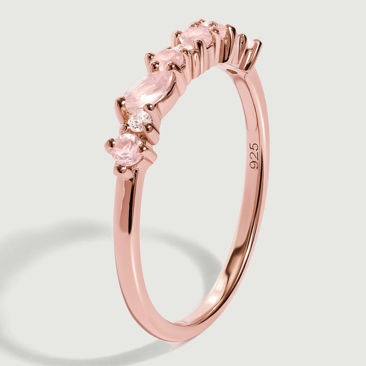 An upright rose gold band reveals raised pink stone settings and a visible 925 stamp inside the ring.