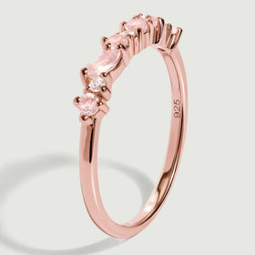 An upright rose gold band reveals raised pink stone settings and a visible 925 stamp inside the ring.