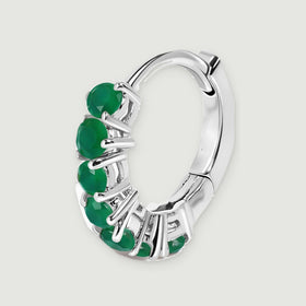 A single white rhodium plated hoop reveals its open center, green stone row, and hinged back.