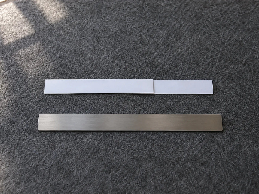 Natural window light illuminates a flattened plain paper strip with a single overlap mark beside an unmarked straight ruler.