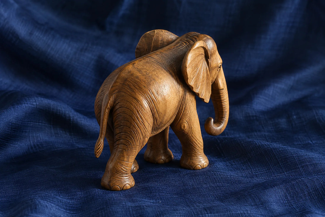 Natural window light illuminates one small wooden elephant sculpture with a complete trunk and ears.