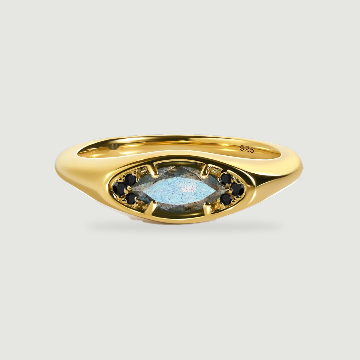 A yellow gold vermeil ring shows its horizontal labradorite centerpiece and rounded shoulders on a pale gray background.