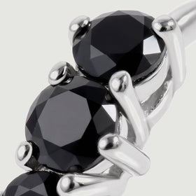 This close view shows black onyx facets and bright white rhodium plated settings.