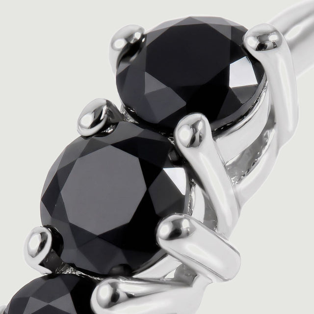 This close view shows black onyx facets and bright white rhodium plated settings.