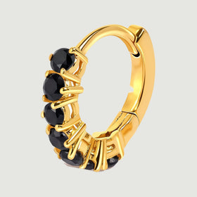 A single yellow gold plated hoop reveals its curved frame and row of black stones.
