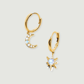 Yellow gold hoops carry a moonstone crescent and a moonstone starburst against a light gray background.