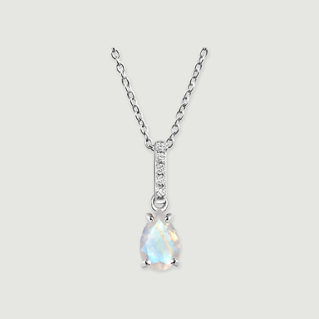 A silver chain supports a pale blue pear-shaped moonstone and a slim stone-set bail against light gray.