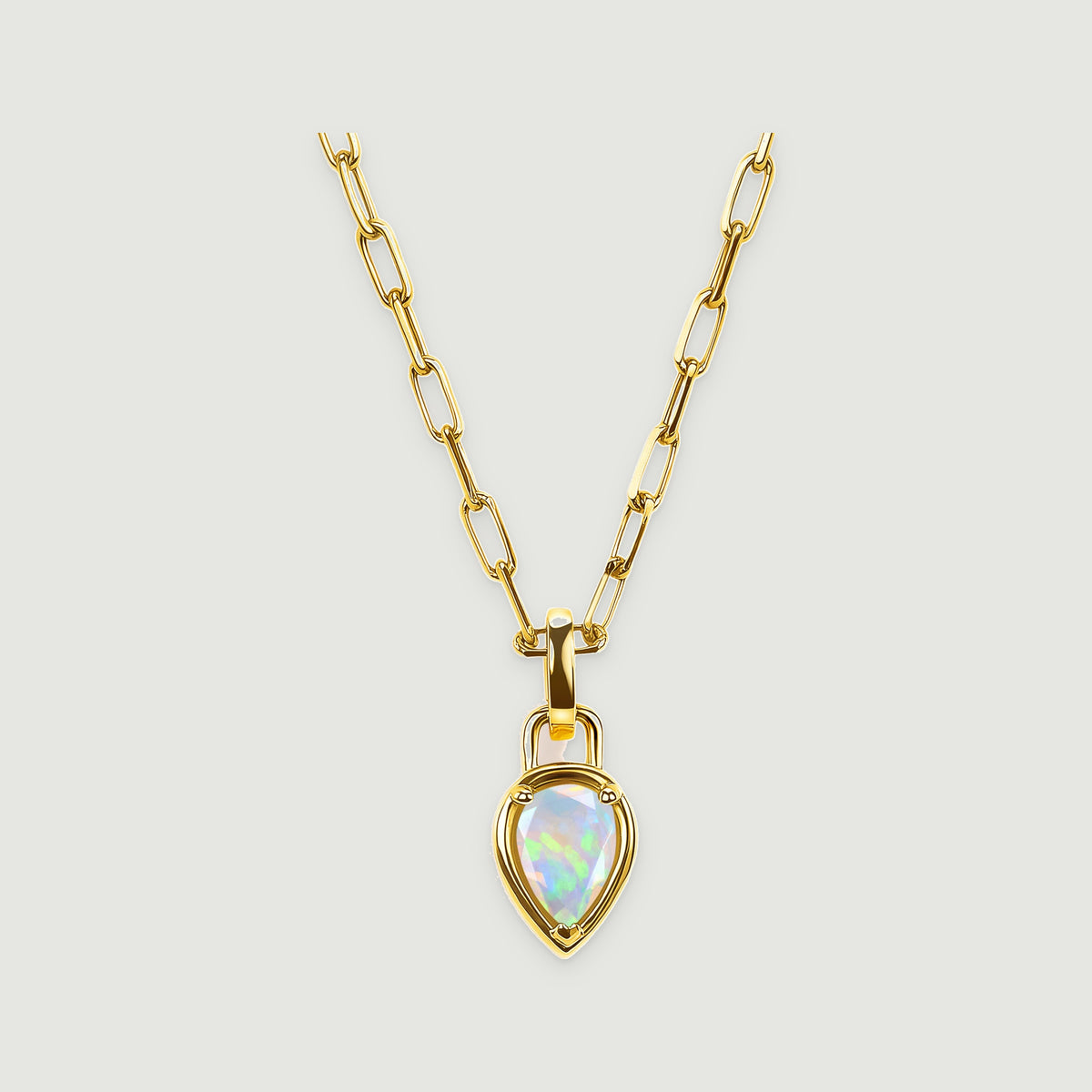 A pear-shaped opal pendant hangs from an elongated yellow gold link chain against a light gray background.