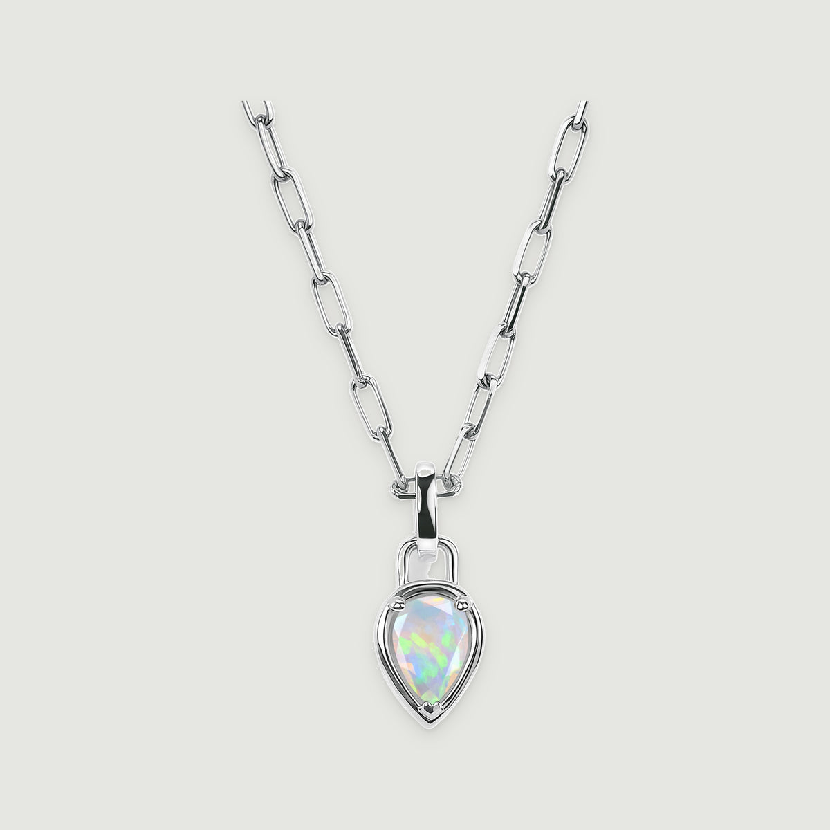 A white rhodium link necklace with a pear-shaped opal pendant is centered on a pale gray surface.