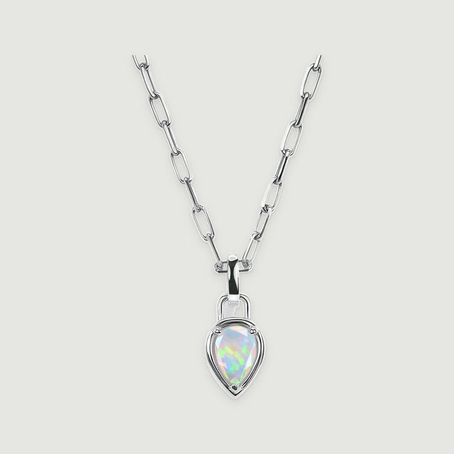 A white rhodium link necklace with a pear-shaped opal pendant is centered on a pale gray surface.