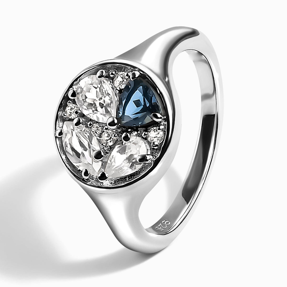 The silver ring stands at an angle with its inner band and 925 stamp visible.