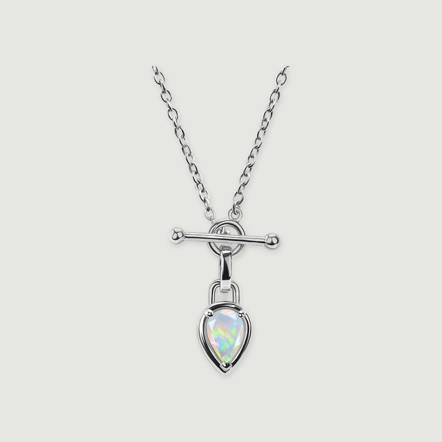 A bright silver-colored necklace with a pear-shaped opal suspended below a circular connector is centered on light gray.