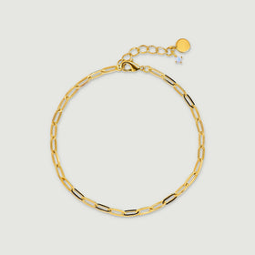 A yellow gold plated open-link anklet forms an oval with a lobster clasp and extension chain on light gray.