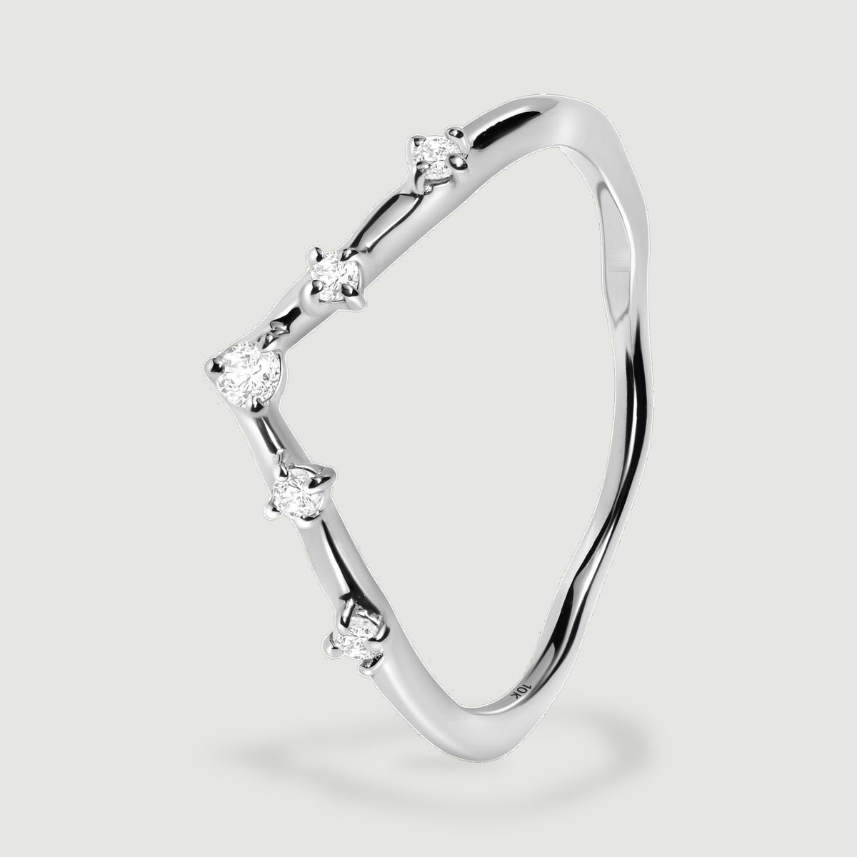 An angled side view of the white gold ring shows five round diamonds along the contoured band.