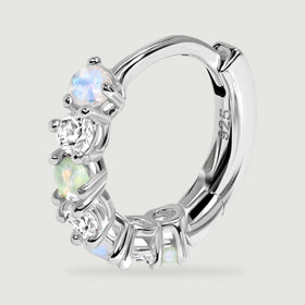 A single silver hoop is seen at an angle with the polished inner curve and stone settings visible.