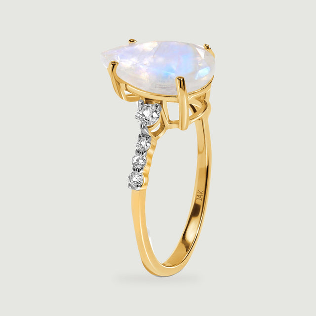 The raised moonstone basket and slim yellow gold band are shown from the side.