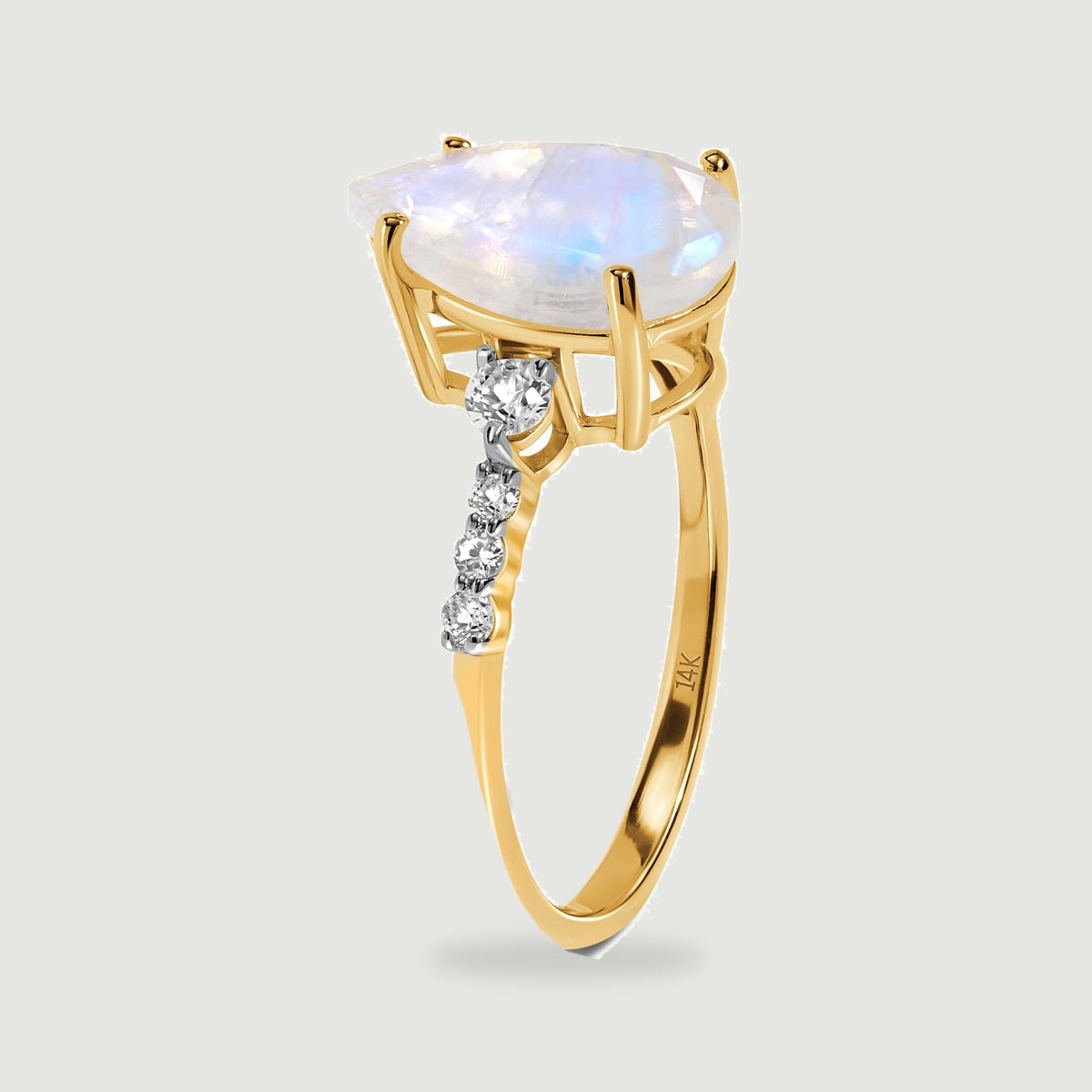 The yellow gold ring is shown upright with its open setting and graduated diamond shoulders visible.