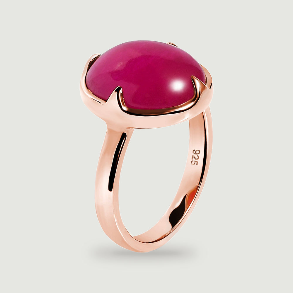 An angled side view shows the raised pink cabochon and the full rose-gold ring band.