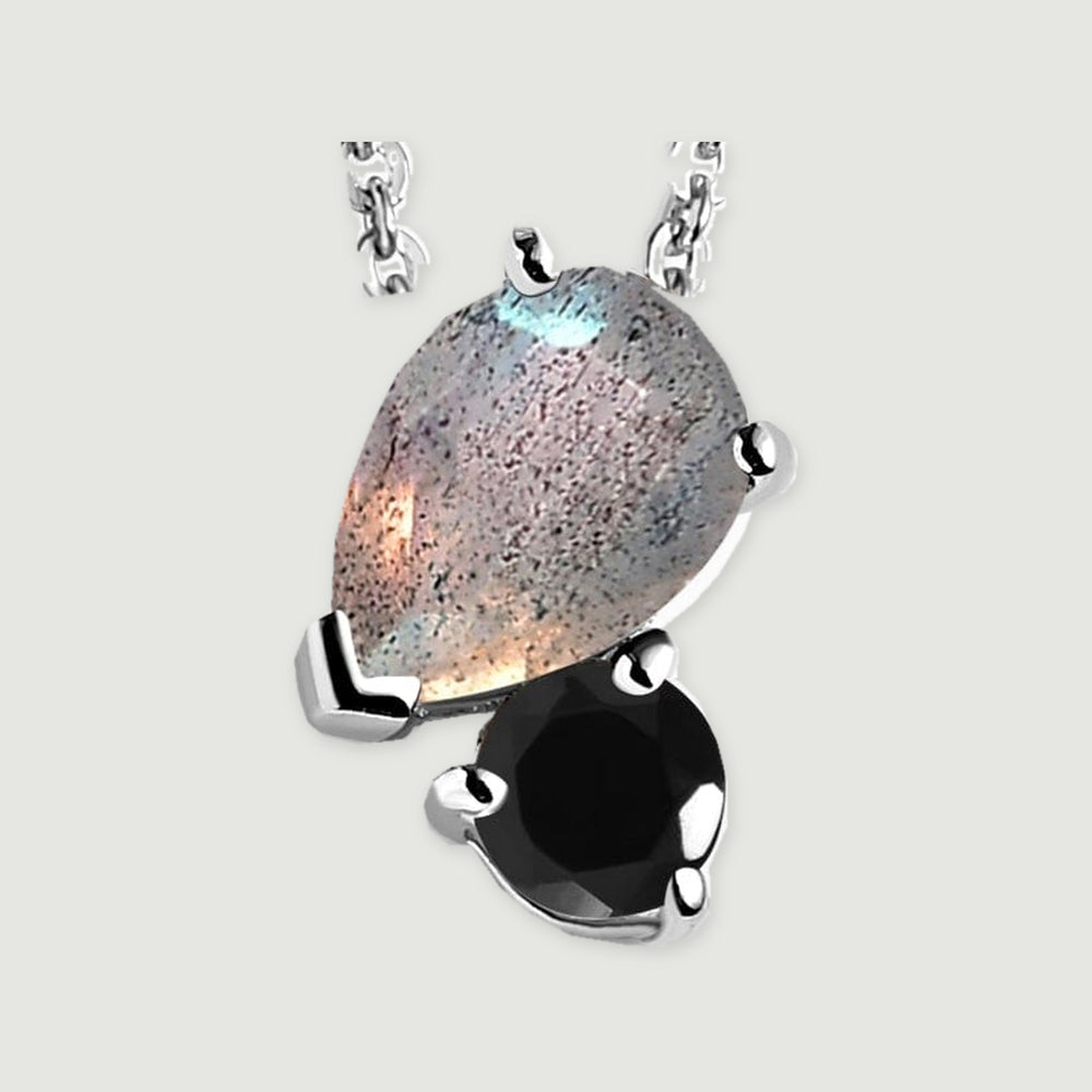 A close view shows silver prongs around a flecked pear-shaped labradorite and a glossy round black obsidian.