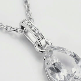 A close view shows five round stones in the silver bail beside the clear pendant and polished connecting ring.