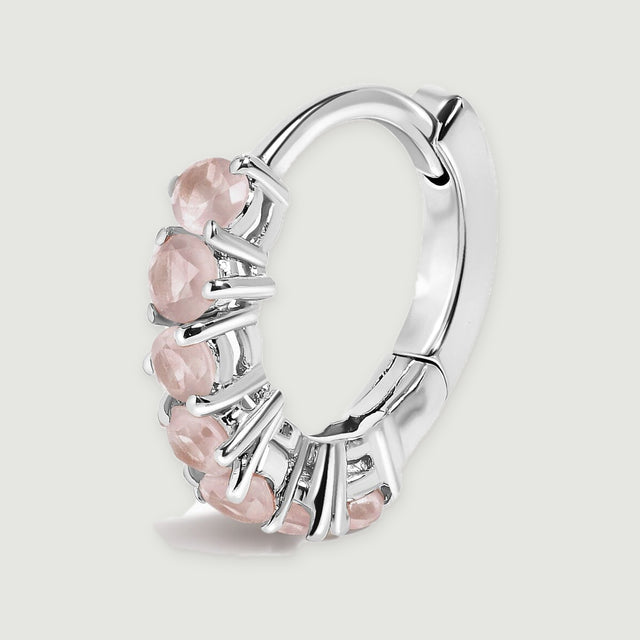 A single silver-tone rose quartz hoop shows its curved back and hinged closure against light gray.