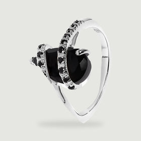 An angled silver ring reveals the raised black stone, supporting prongs, and curved band.