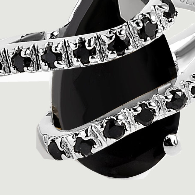 A close view shows the silver prongs and small black stones along the two curved rows across the pear-shaped stone.