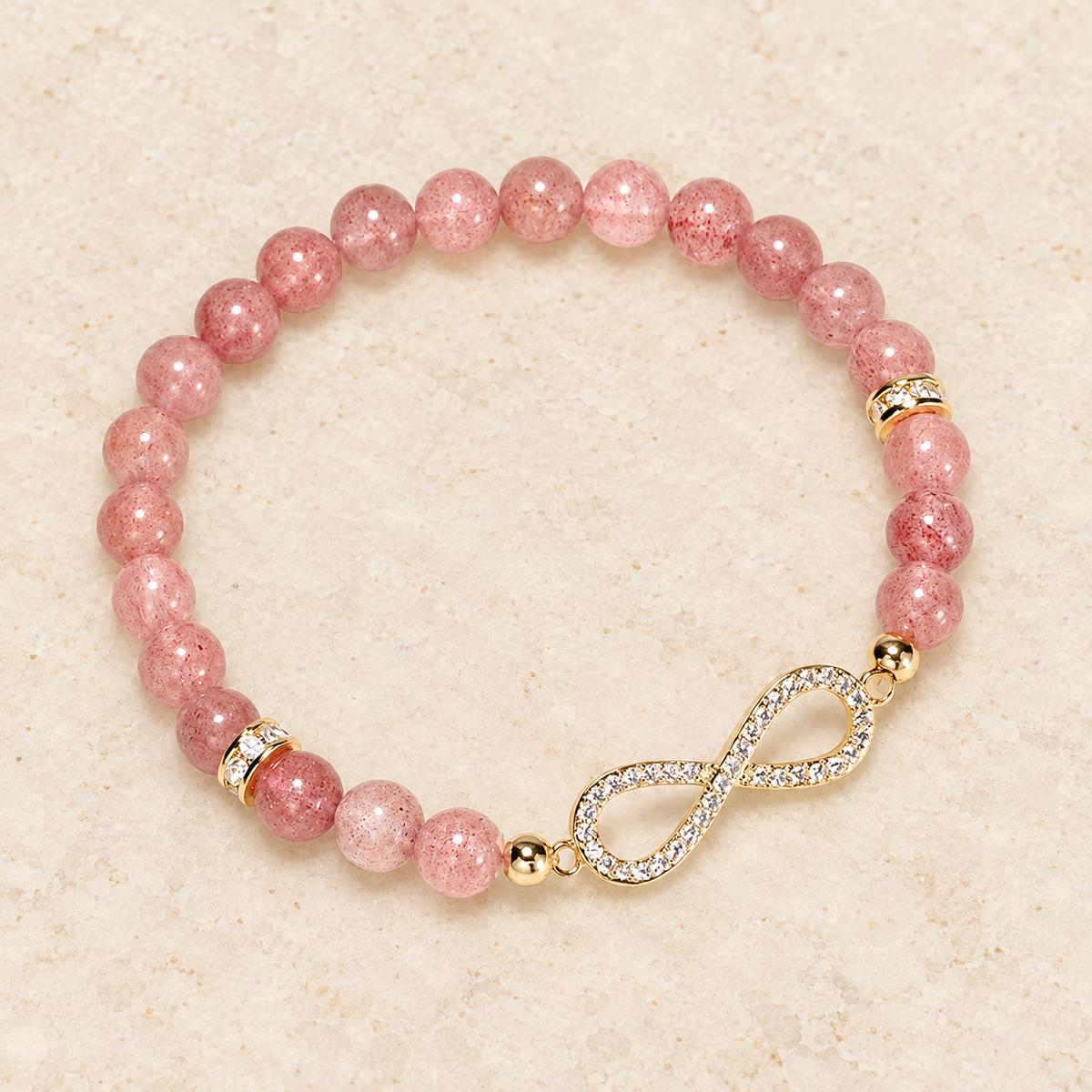 Overhead angled view of the pink bead and infinity bracelet.