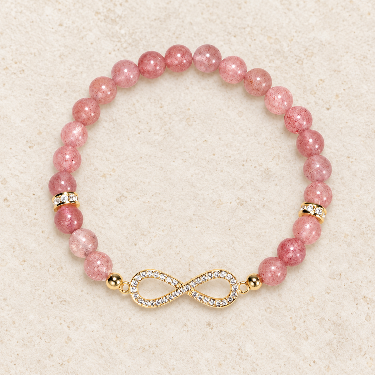 Top view of the pink bead bracelet with the infinity centerpiece at the front.