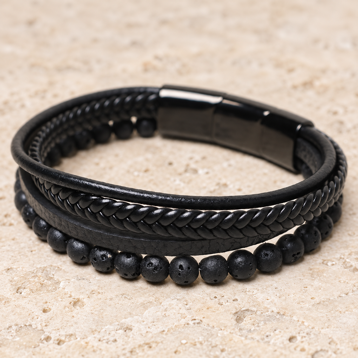 Angled view of the lava-bead Dark Texture bracelet and its black clasp.