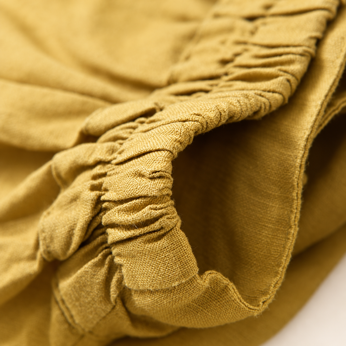 Ease pants in Yellow, elastic waistband and fabric texture close-up.