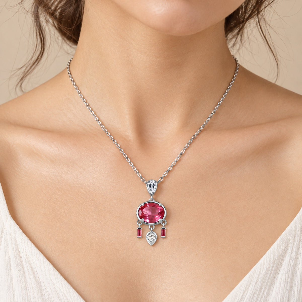 Pink topaz necklace with white zircon accents resting at the collarbone