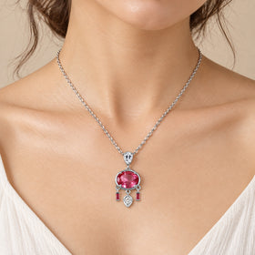 Pink topaz necklace with white zircon accents resting at the collarbone